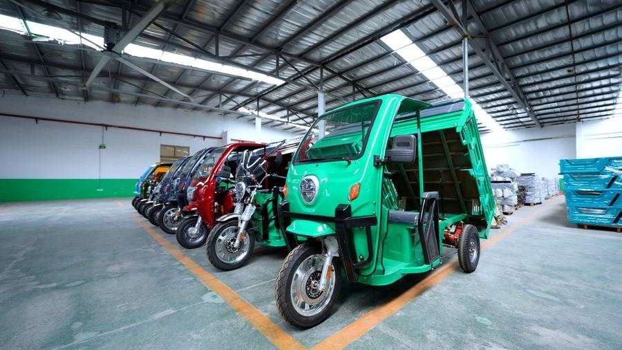 Finished electric tricycles lined up in our export showroom
